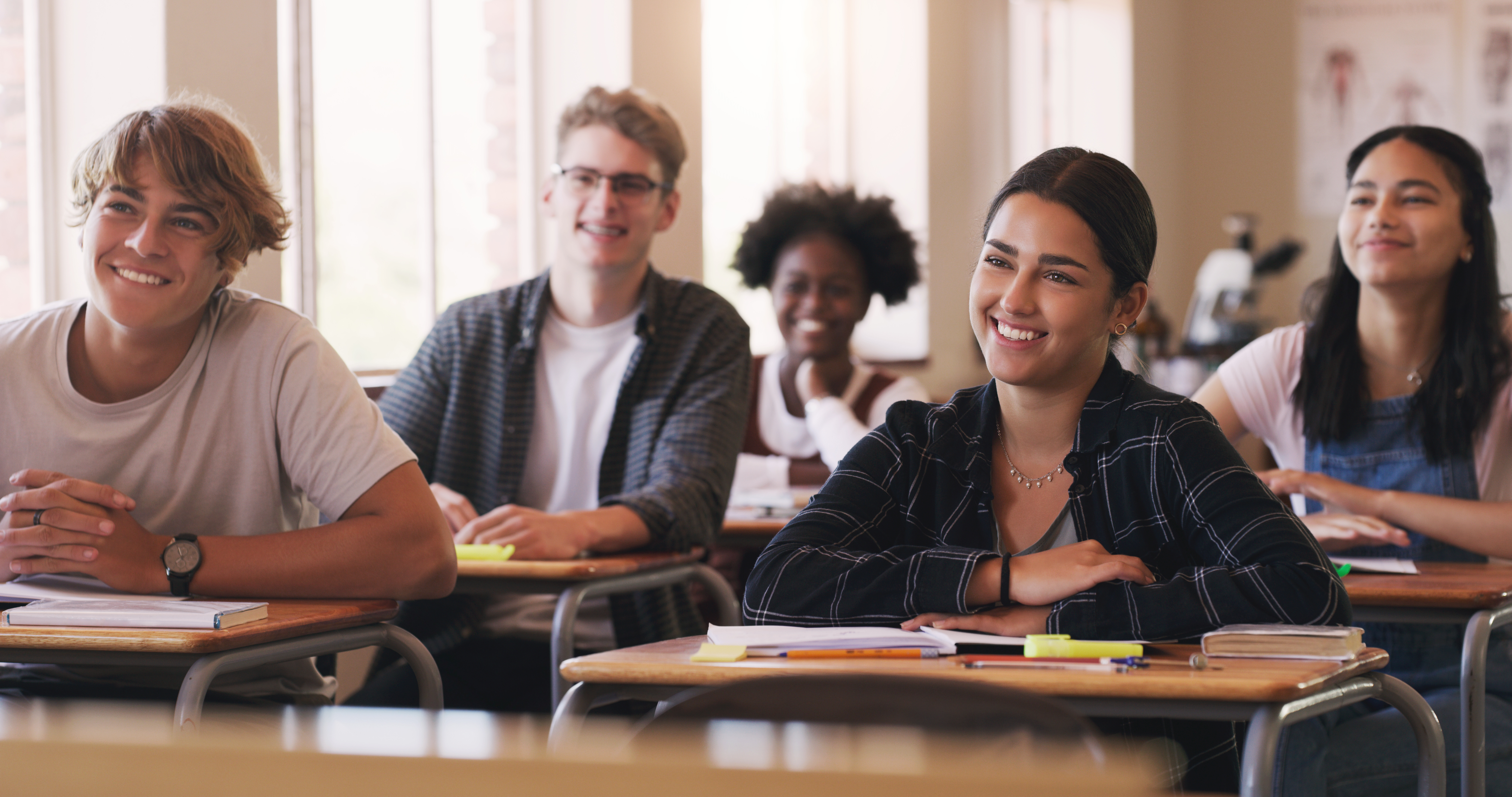 Shot of a group of teenagers in a classroom at high school.